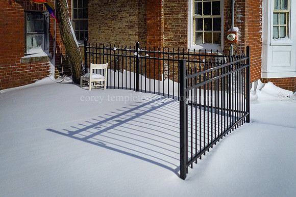 Dramatic Fence Shadow on Gray Street