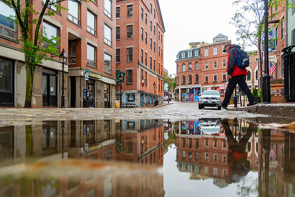 Man and Puddle Reflection on Rainy Moulton Street