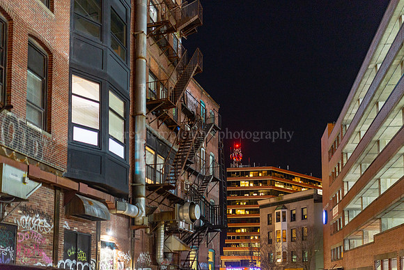 Gritty Fire Escape Stairs behind Monument Square at Night