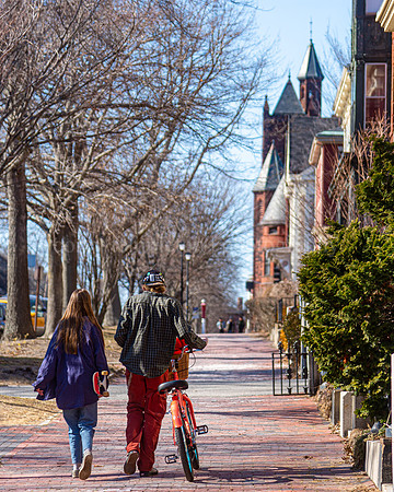 Walking up State Street with a Skateboard and a Bicycle